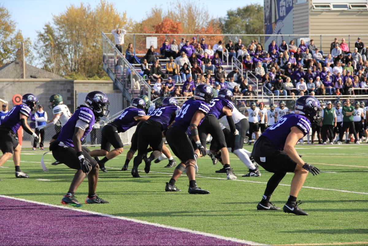 The Winona State football team displays their solid defense at the end zone.